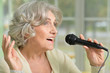 © aletia2011 - senior woman singing with microphone