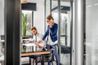 © rh2010 - View through the open door on the luxury office interior with business couple working