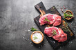 © nadianb - Raw beef steak with herbs.