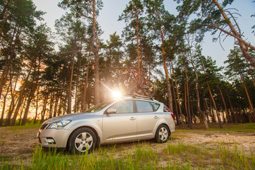 Car is transporting bicycles on the roof. bikes on the trunk. Summer. Vacation. Sport sunset.