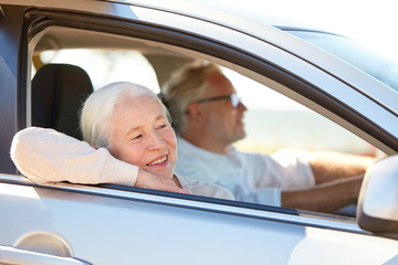 Canvas Print - happy senior couple driving in car