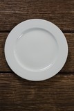 Fototapeta  - White plate on wooden table