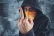Hooded gang member criminal showing middle finger