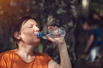 Woman drinking water outdoors