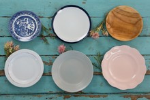 Empty Plates With Flower On Wooden Table