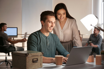 Canvas Print - Young co-workers having late night meeting in office