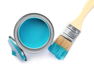 Can of blue paint and brush on white background, top view