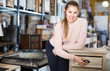 © JackF - Woman buyer standing in furniture shopping room near chest of drawers