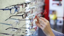 choosing eyeglasses in optics shop