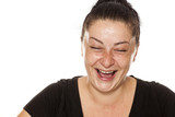 Fototapeta  - young laughing freckled woman with no makeup on a white background