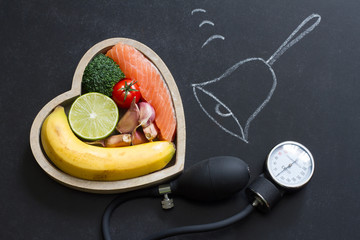 Wall Mural - Time for health heart abstract diet food concept on blackboard with bell
