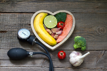 Wall Mural - Health heart diet food concept with blood pressure gauge
