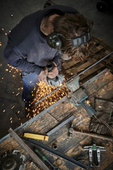 Wall Mural - young farmer working with a grinder