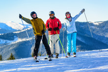 Three Happy Skiers Having Fun On Winter Ski Slope