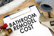Clipboard with words bathroom remodel cost. Renovation estimate.