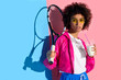 © LIGHTFIELD STUDIOS - Young bright african american girl holding tennis racket and plastic cup with drink on pink and blue background