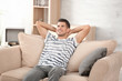 © Africa Studio - Handsome man resting on sofa at home
