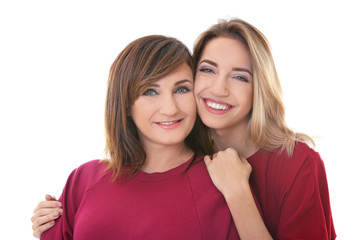 Canvas Print - Attractive young woman with her mother in matching dresses on white background