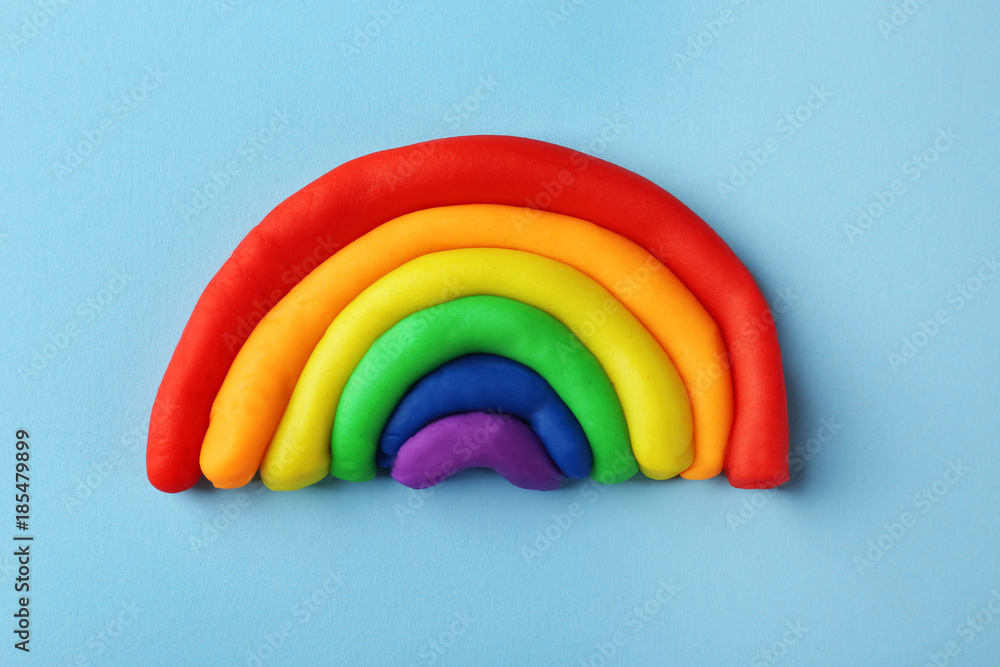Plasticine rainbow on color background