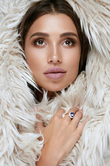 Beauty Makeup. Woman Face With Beautiful Facial Skin In Fur