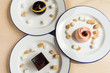 Variety of desserts on the table with white plates and marshmallows. Cherry, chocolates