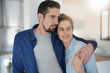 © goodluz - Middle-aged couple standing together in home kitchen
