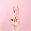 Hand holding pink macaroon