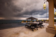 © Annatamila - Storm coming up and dark clouds above Swimming pool with sea view in luxury villa, weather and rainy season