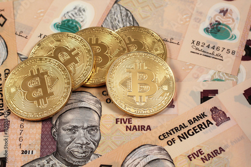 A Close Up Image Of Golden Bitcoins Close Up With Nigerian Naira - 