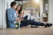 © goodluz - Couple cheering with champagne in new home