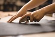 © Wavebreak Media - Close up of female worker's hand cutting leather with cutter