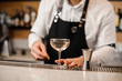 © fesenko - Barman with an elegant glass filled with drink