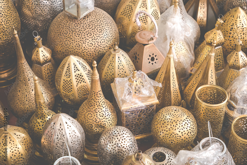 Selection of traditional lamps on sale at a market stall in souks of Marrakech, Morocco.
