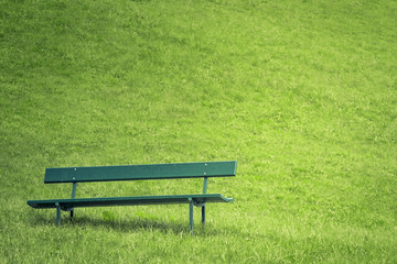 Abandoned park bench in apublic garden.