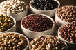 Assorted beans in bowls on wood background