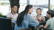 © allensima - Asian family smiling, eating & drinking outdoor at streetside table