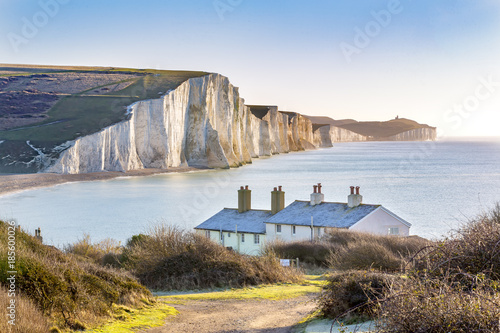 Fotografie, Obraz The Coast Guard Cottages and Seven Sisters Chalk Cliffs just outside Eastbourne, Sussex, England, UK