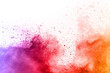 © kitsana - abstract multicolored powder splatted on white background,Freeze motion of color powder exploding.