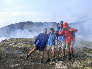 photo on the summit of etna disturbed by sulfur gas - tourist running away when sulfur gas appeared 