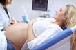 Cheerful pregnant woman on ultrasound