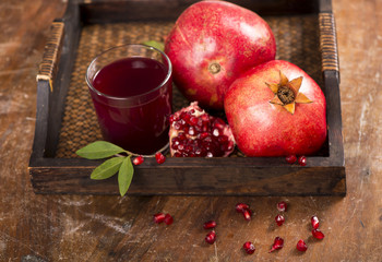 Sticker - pomegranate juice on a wooden background