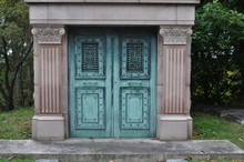 Blue Cast Iron Mausoleum Doors In A Cemetery