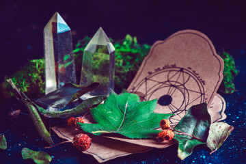 Wall Mural - Pentagram drawing on a parchment with potion ingredients and crystals in a magical scene. Modern witchcraft concept with copy space. Dark still life photography.