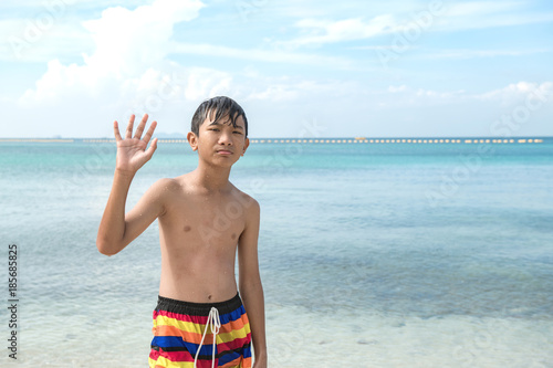 Young Chinese Boy On Beach Portrait Young Boy Standing In Ocean Waving At Camera Chinese Asian Boy Tanned Skin Stock Photo Adobe Stock Young Chinese Boy On Beach Portrait Young Boy Standing In Ocean Waving At Camera Chinese Asian Boy Tanned Skin Stock Photo Adobe Stock