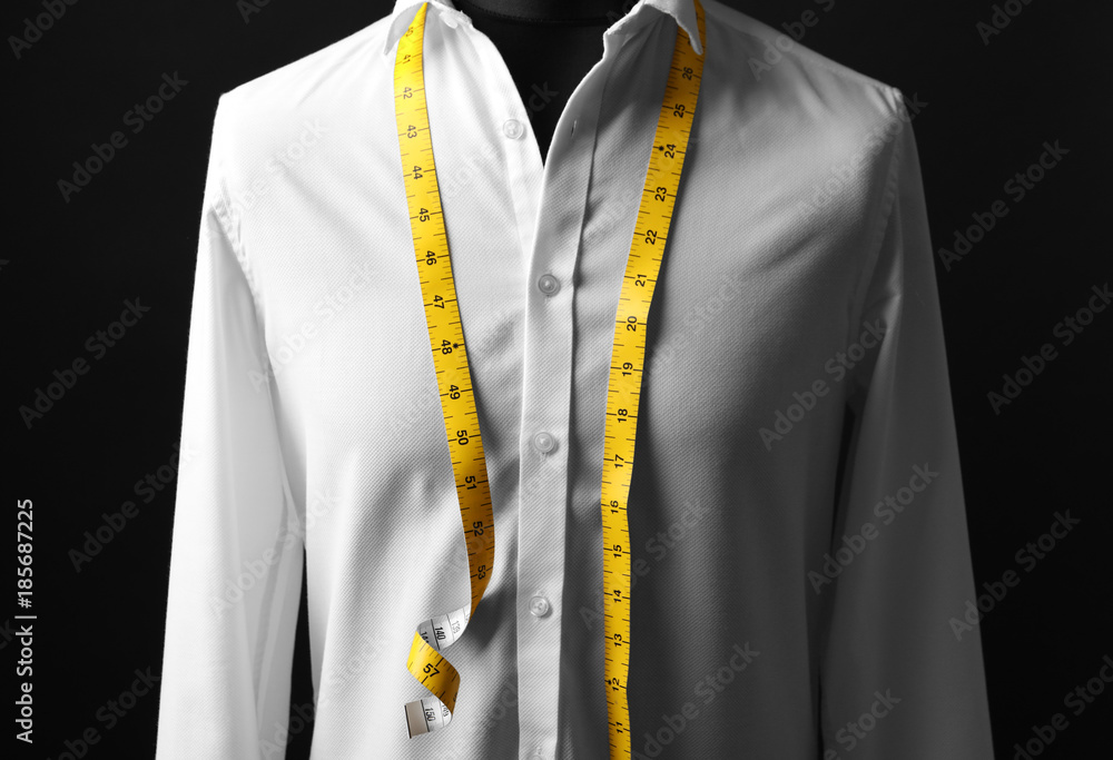 Elegant custom made shirt on mannequin against black background, closeup