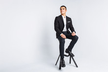 Portrait Of The Beautiful Posing In A Studio, White Background, Stylish Business Man, Stylish Man Sitting On A Designer Chair