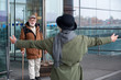 © Yakobchuk Olena - After long separation. Back view of elegant senior woman is going to hug her smiling gray-haired husband who is exiting from airport building. Focus on man with suitcase