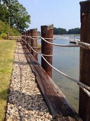 rope fence with posts beside the ocean 