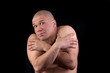 © annatronova - Topless muscular man covered his body with your hands in fear