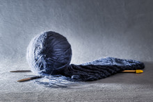 Blue Knitting Wool And Knitting Needles.